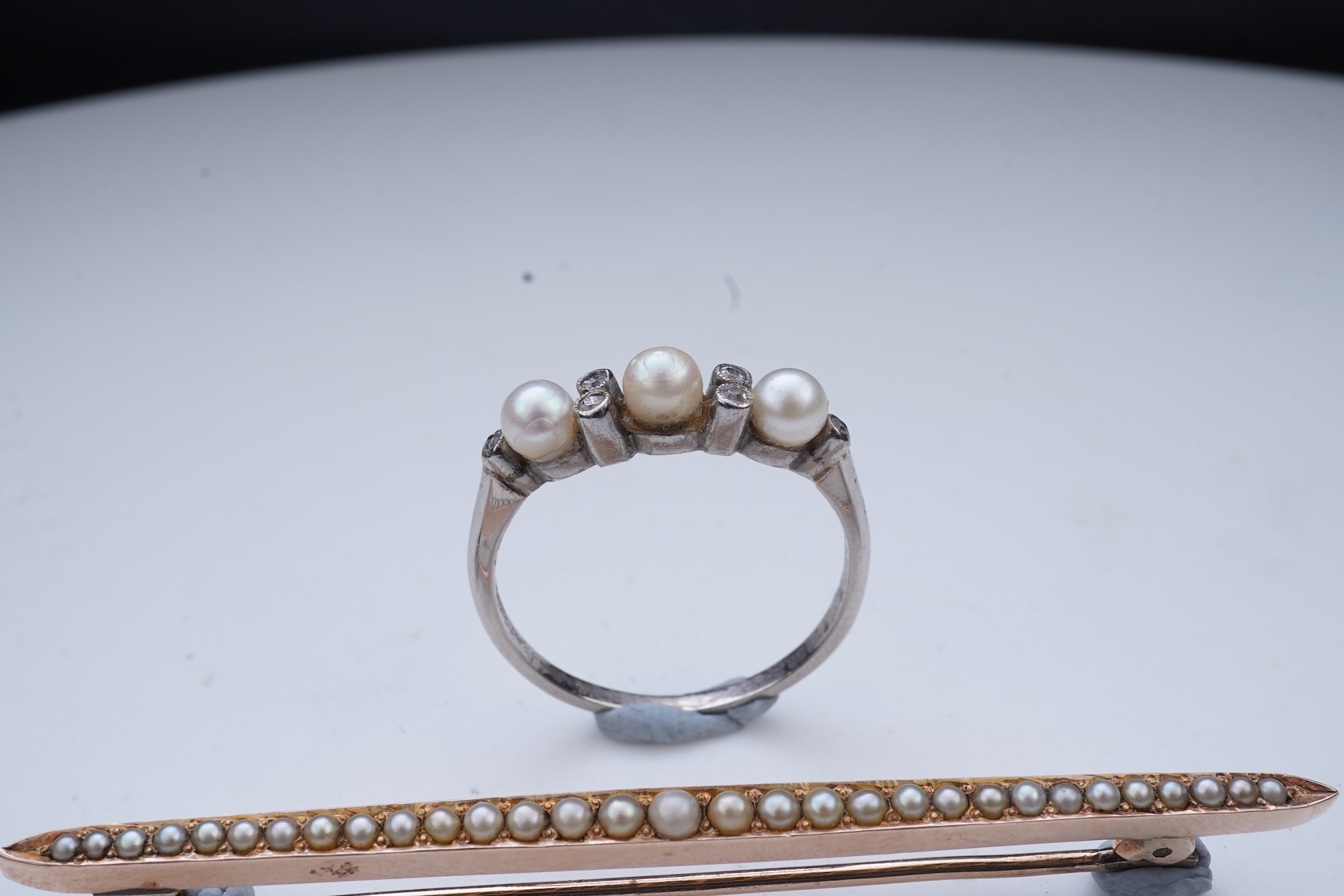 An Edwardian seed pearl brooch and a pearl and diamond ring